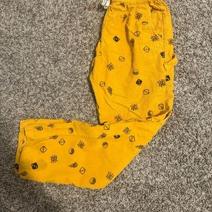 Orange forever 21 cargo pants with black designs on it in a size small